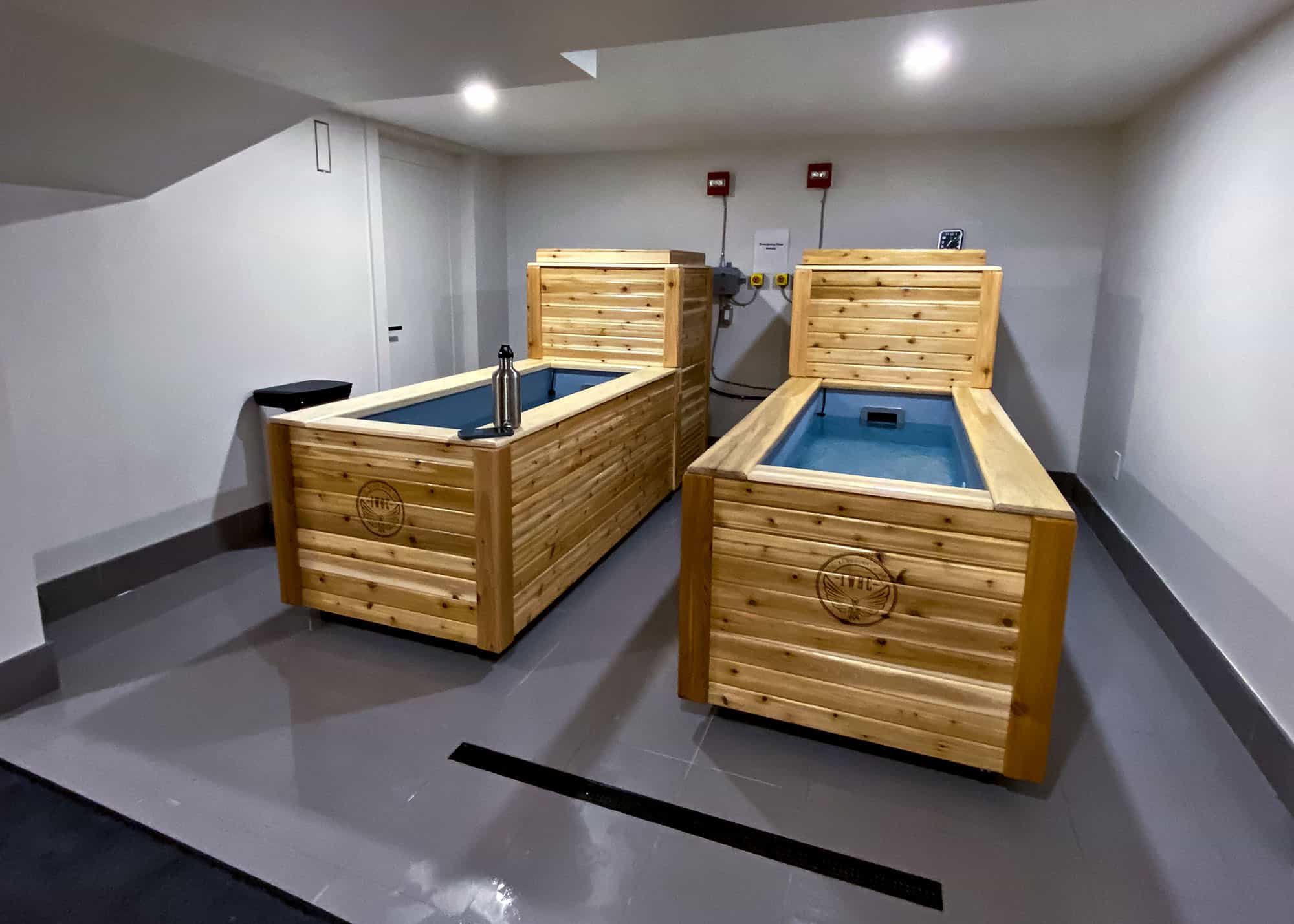 Wooden cold plunge tubs in a modern spa room